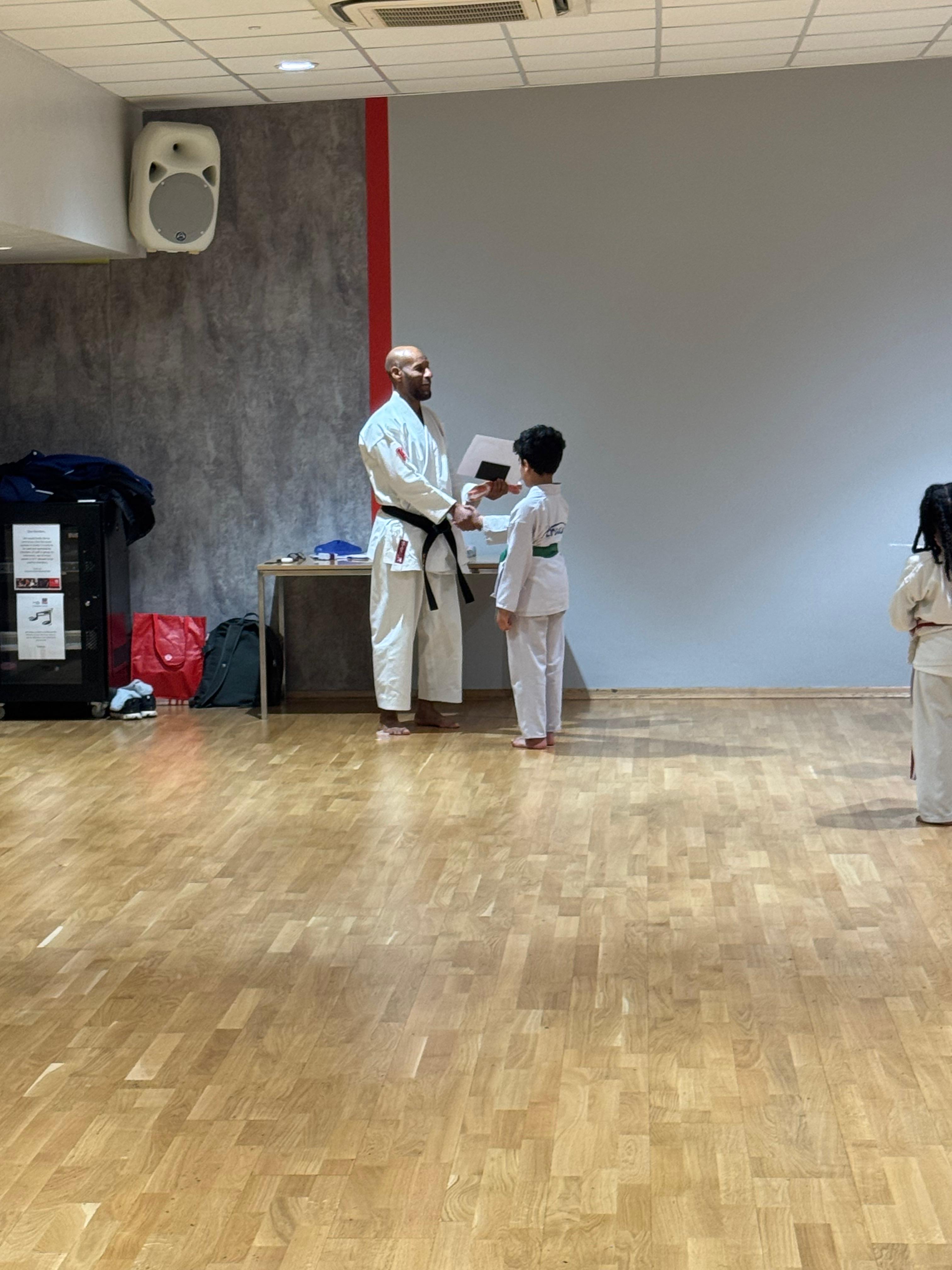 AN Shotokan Karate grading day ceremony with students receiving belts