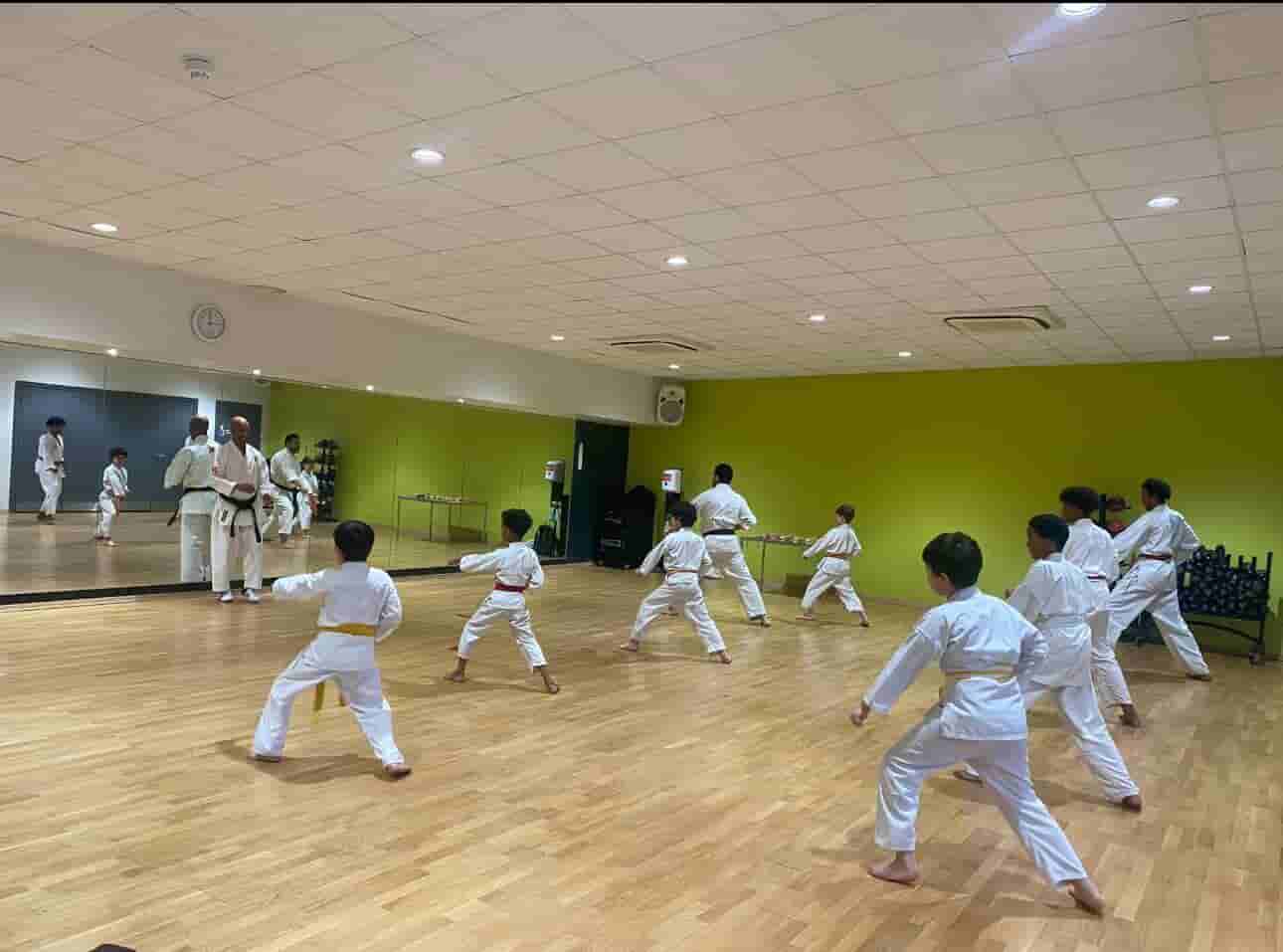 Students practicing Shotokan karate blocks in London dojo